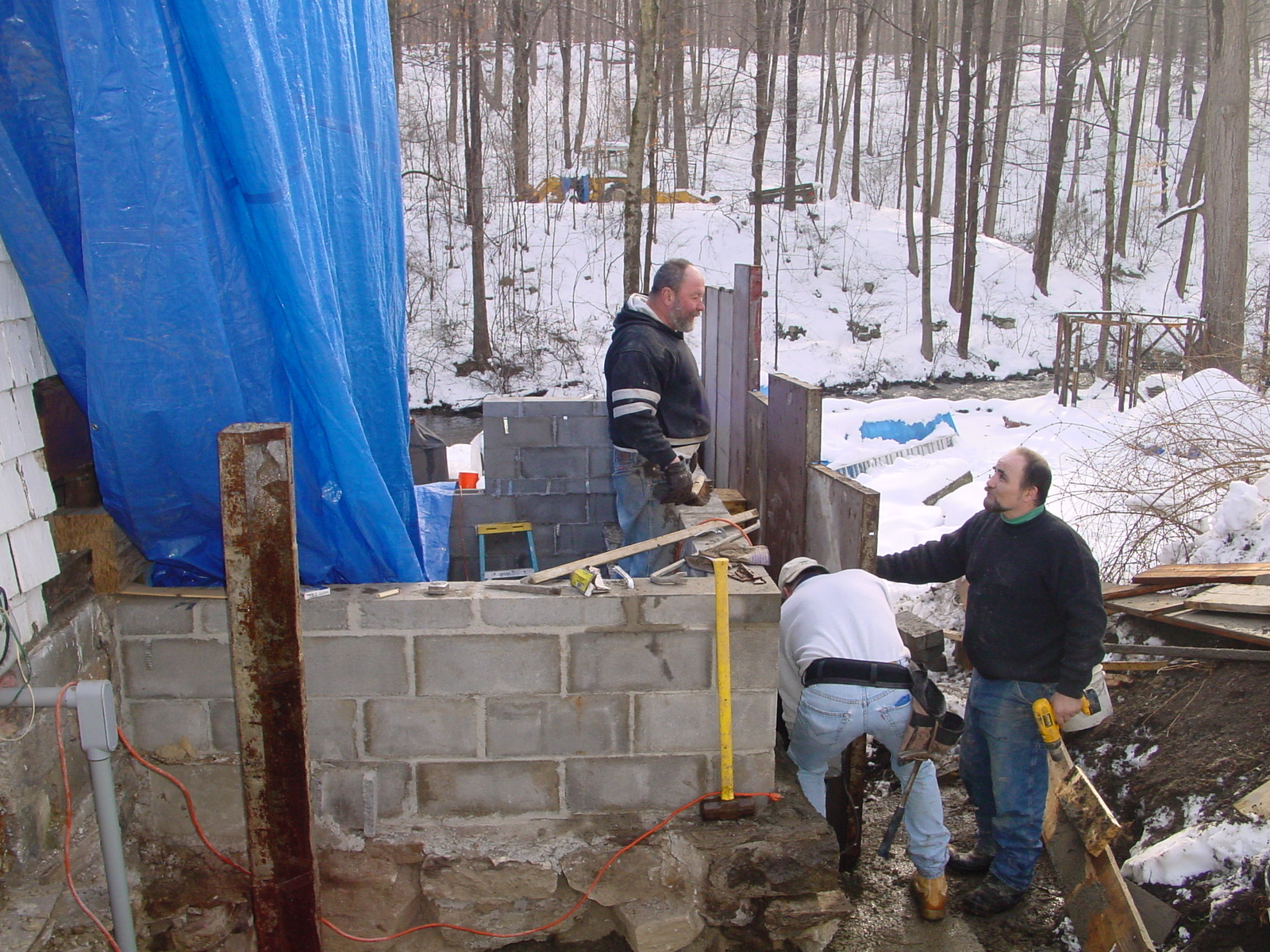 Workers by the master bath foundation and wall