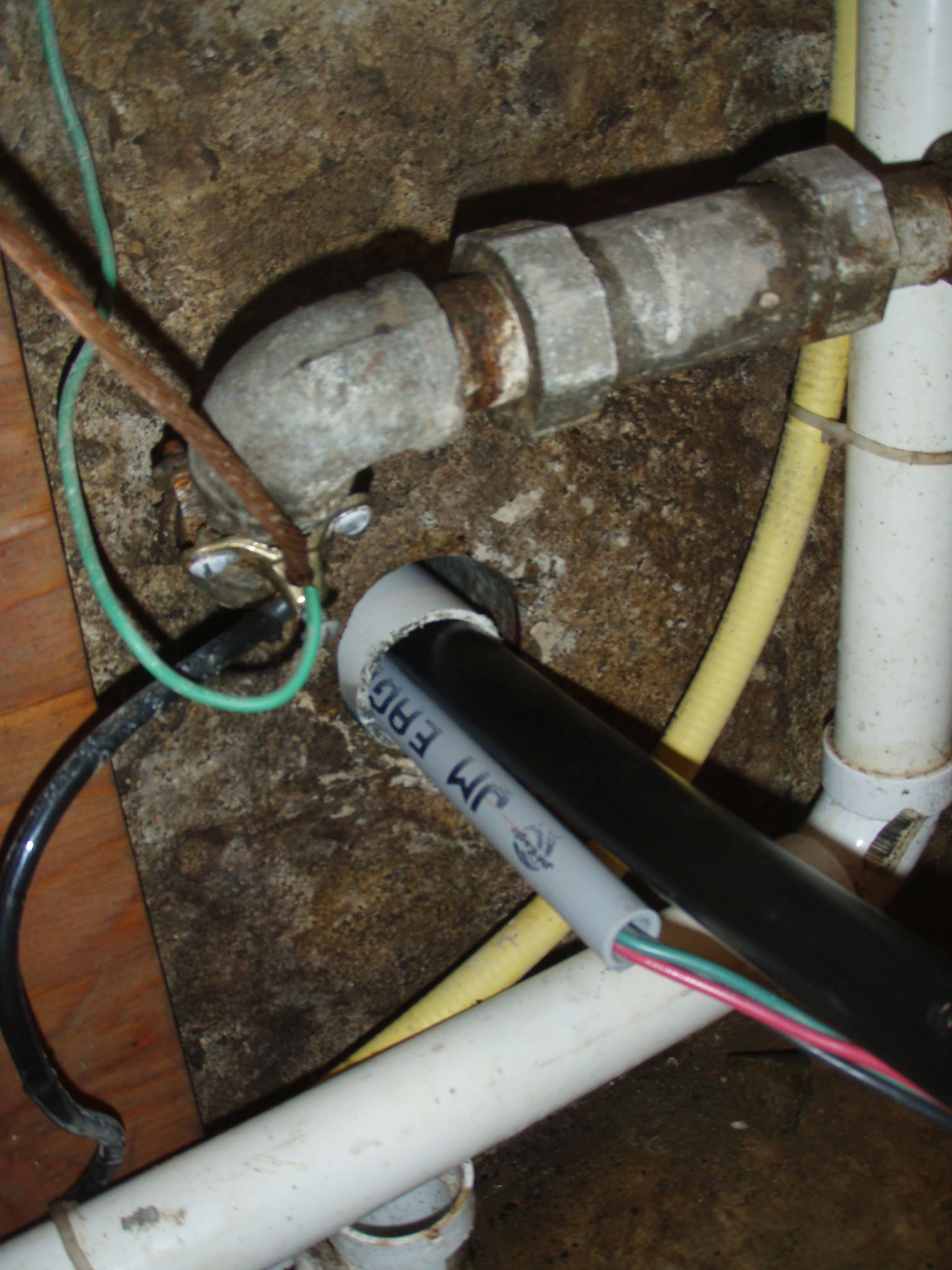 New cement core drill hole with well elec and water tubing